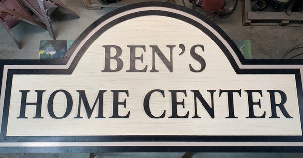 Bens Home Center custom wood-look sign with carved and dimensional details