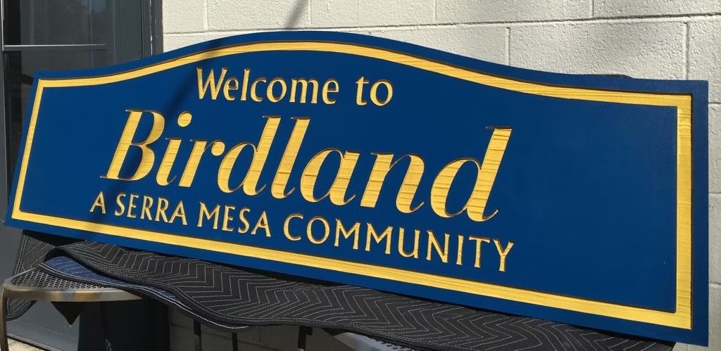 Birdland Sierra Mesa Community custom wood-look sign with carved and dimensional details