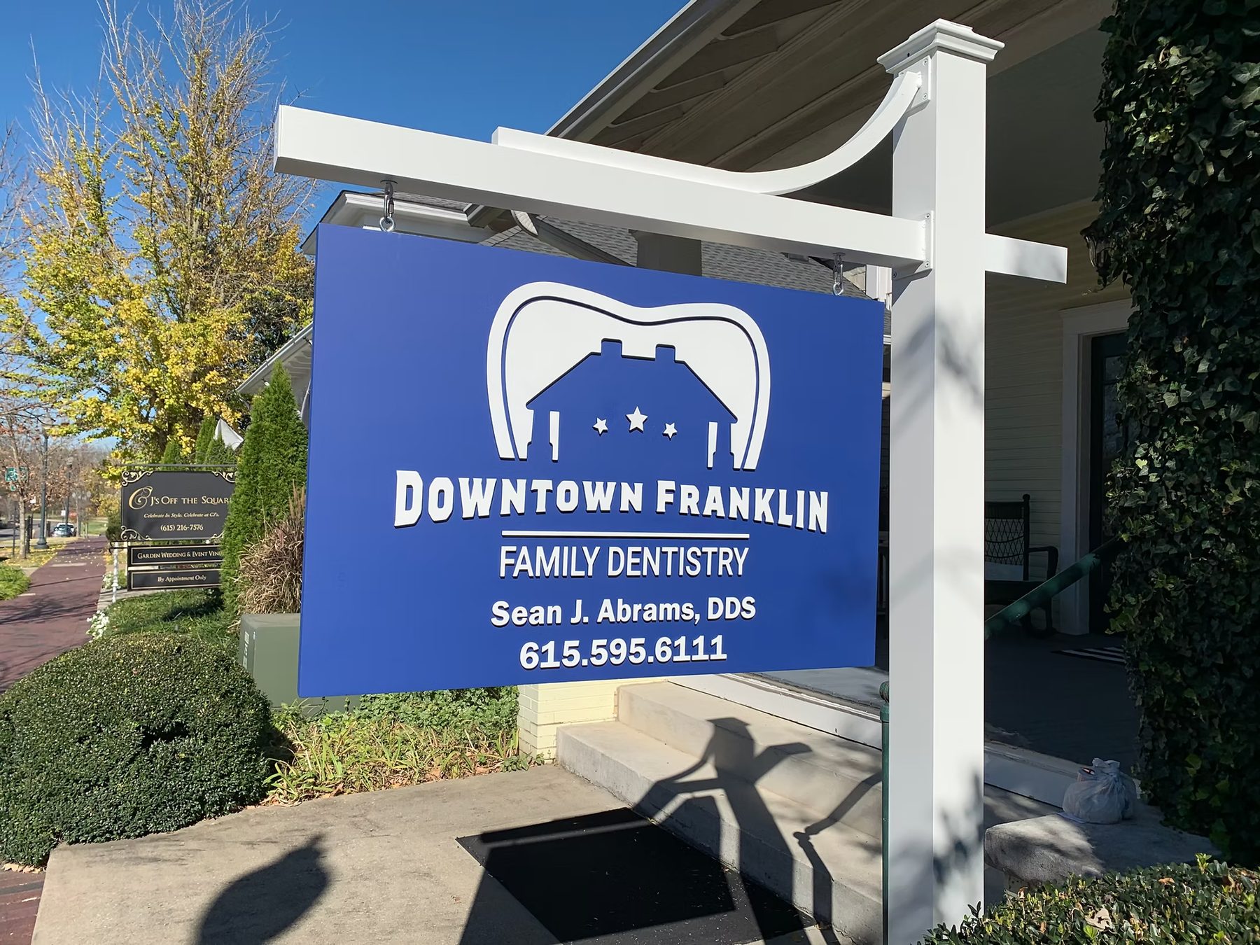 Double Post Custom Entrance Sign Downtown Franklin Family Dentistry custom wood-look sign with carved and dimensional details