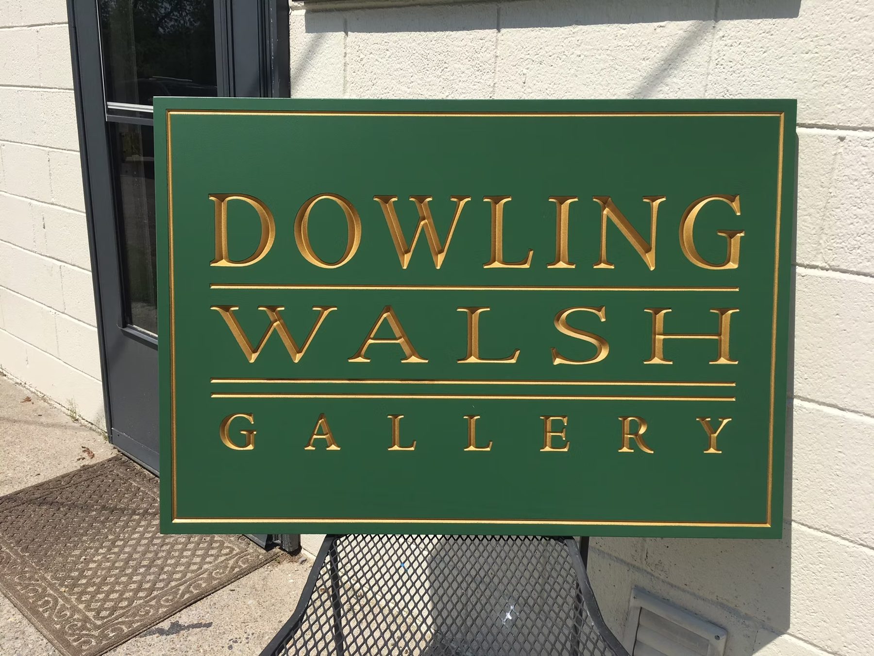 Dowling Walsh Gallery custom wood-look sign with carved and dimensional details