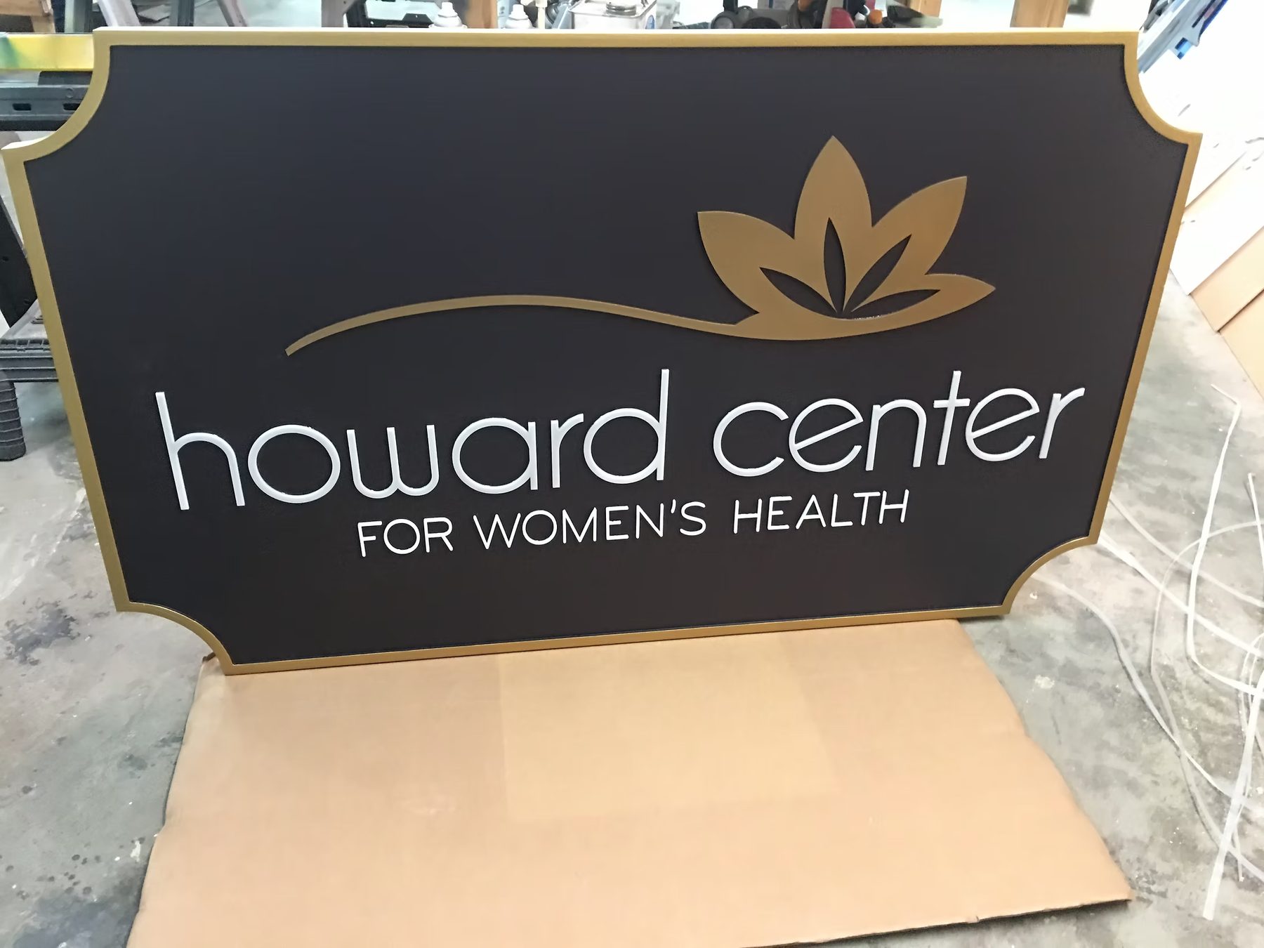 Howard Center Womens Health Routed custom wood-look sign with carved and dimensional details