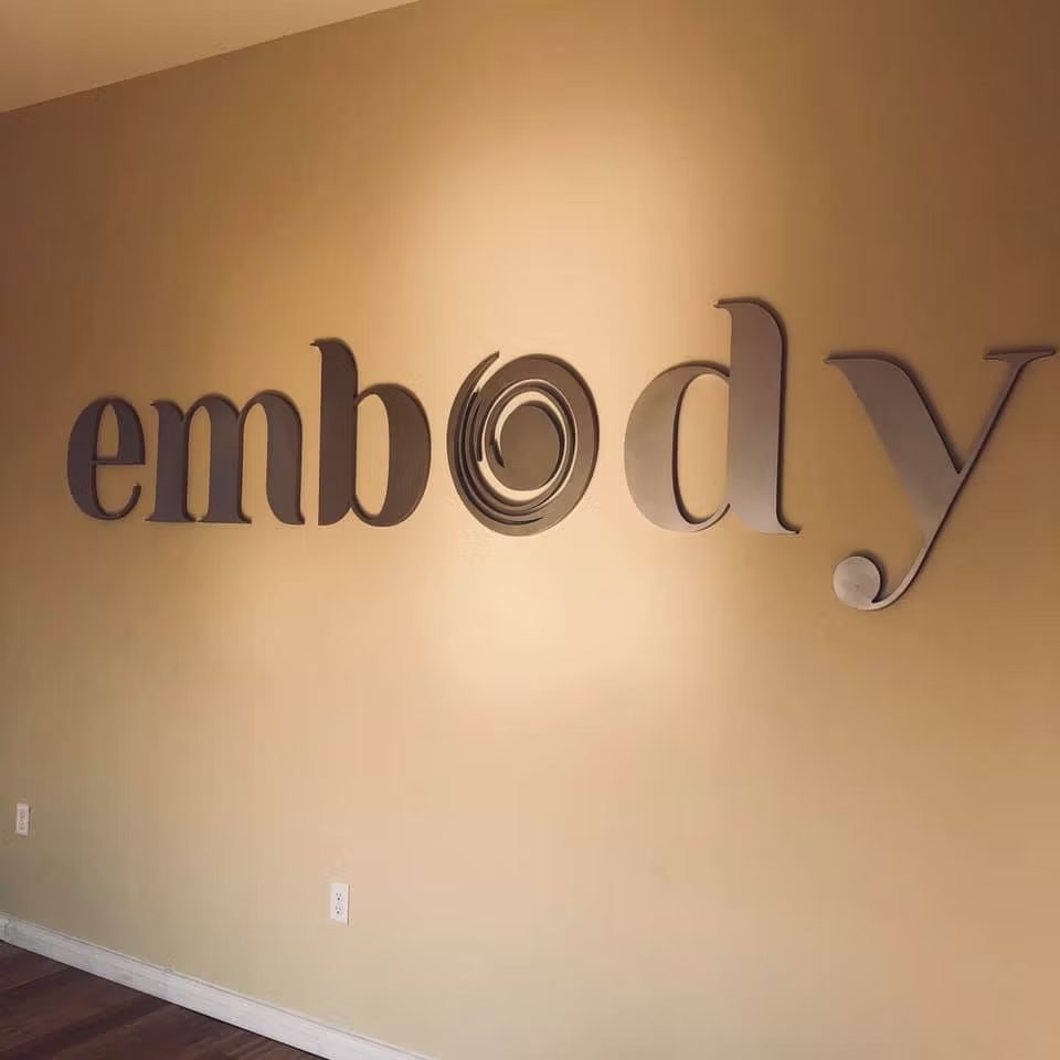 Interior Dimensional Letters Embody Brand Wall custom wood-look sign with carved and dimensional details