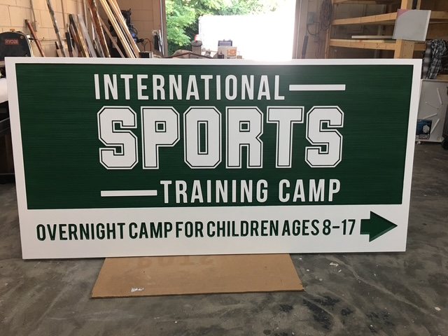 International Sports Training Camp custom wood-look sign with carved and dimensional details