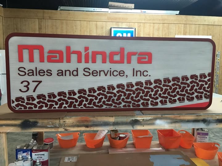 Custom wood-look business sign with dimensional lettering and carved detail
