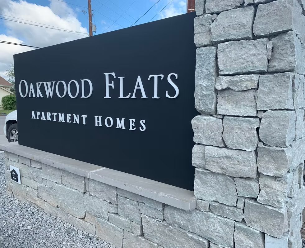 Oakwood Flats Apartment custom wood-look sign with carved and dimensional details