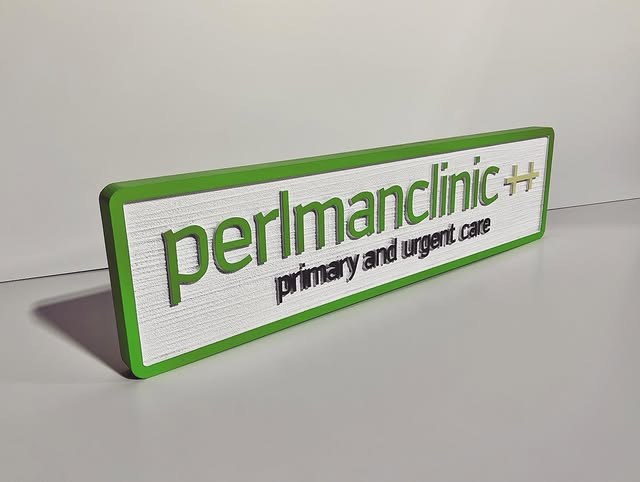 Perlman Clinic Dimensional Desk custom wood-look sign with carved and dimensional details
