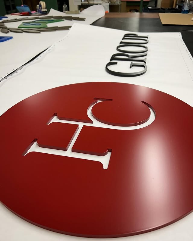 Red Circular Logo custom wood-look sign with carved and dimensional details
