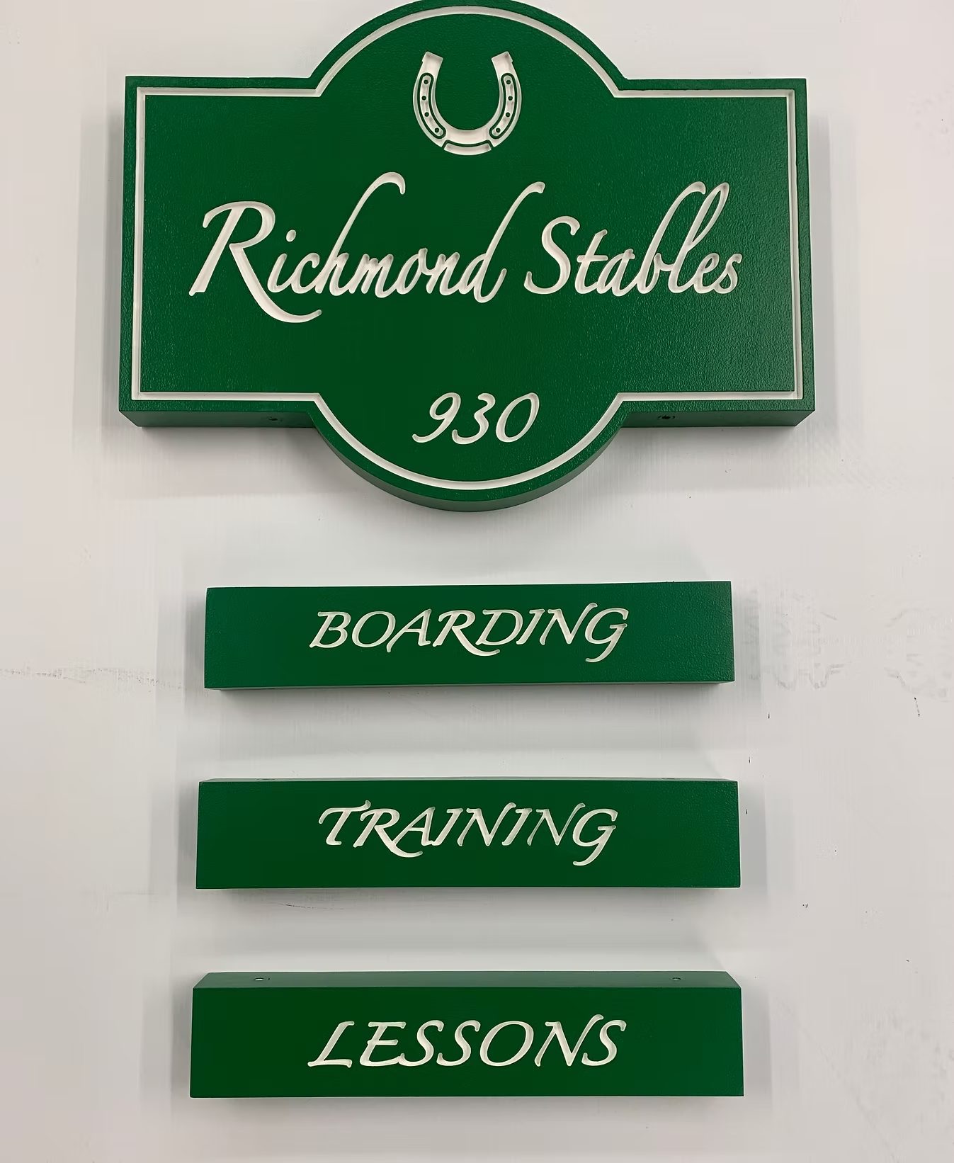 Richmond Stables Directional Sign System custom wood-look sign with carved and dimensional details
