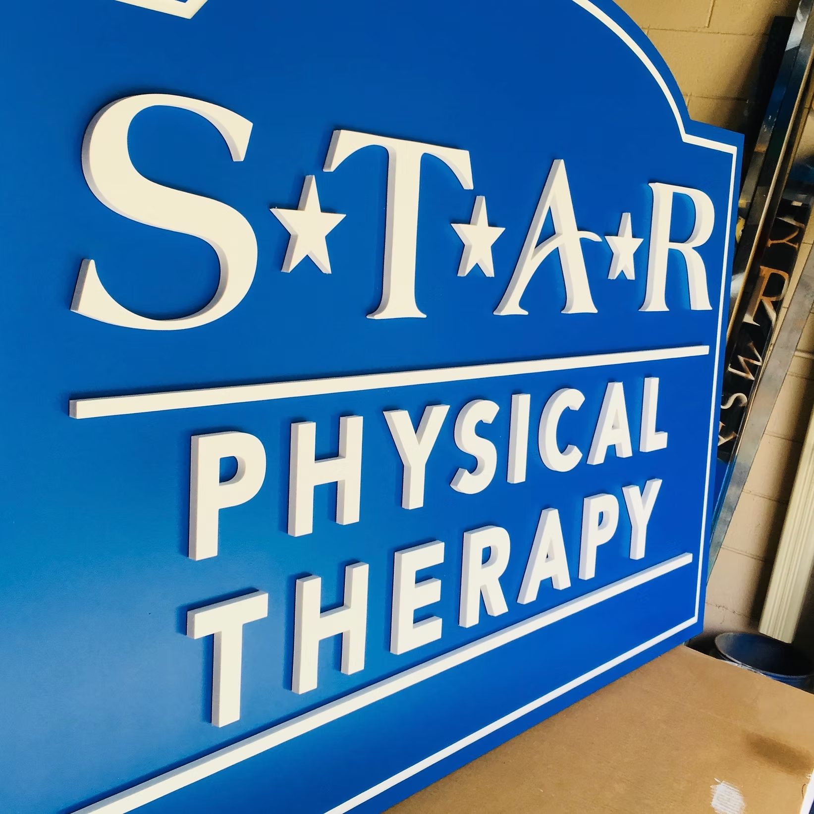 Star Physical Therapy Shaped Dimensional custom wood-look sign with carved and dimensional details