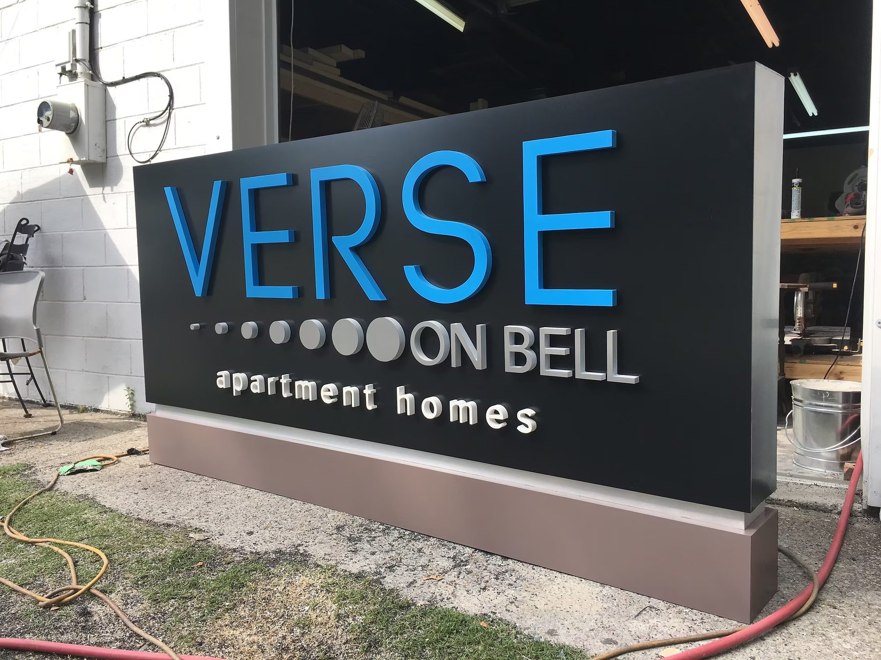Verse On Bell Apartment Homes custom wood-look sign with carved and dimensional details