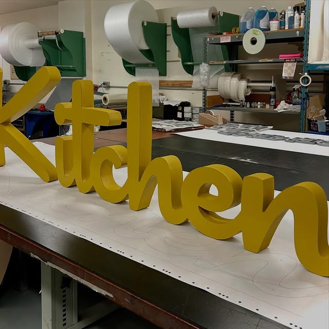 Yellow Script Kitchen custom wood-look sign with carved and dimensional details