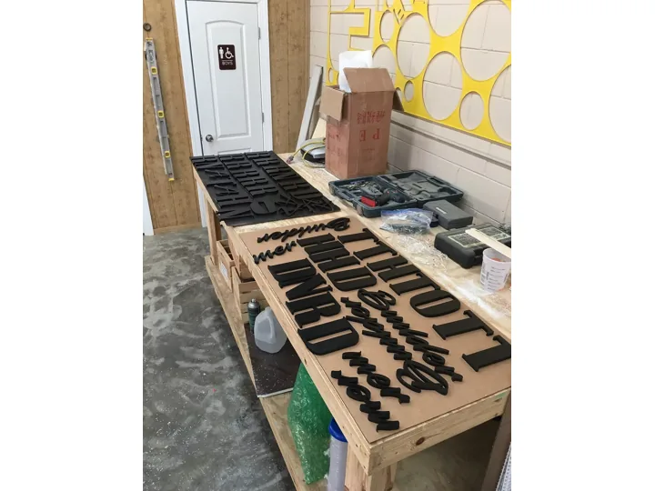 Black Dimensional Letters On Production Table custom wood-look sign