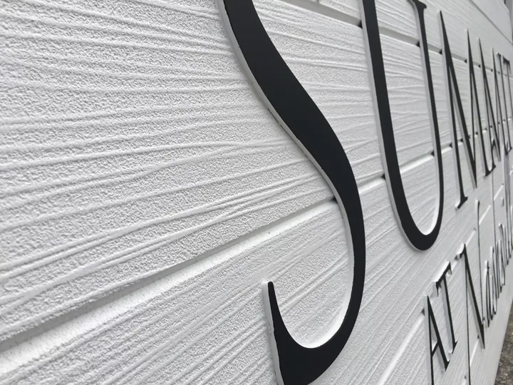 Dimensional Channel Letters On Textured Wall custom wood-look sign